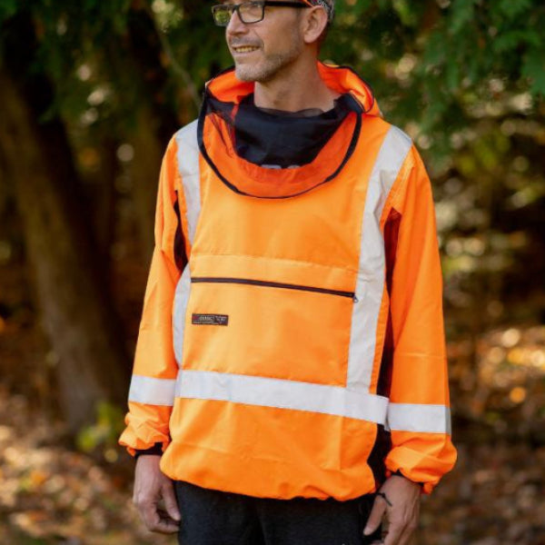 A person wearing a bright orange Hi-Viz Bug Shirt with reflective silver stripes, designed for high visibility in outdoor settings.
