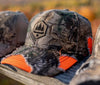 Camouflage ball cap with orange showing through tear marks, OBSC logo, Solid back